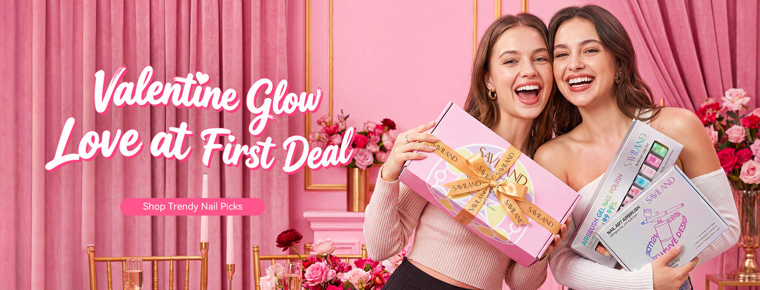 Two women smiling while holding SAVILAND Valentine’s Day nail gift sets in a pink romantic setting
